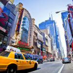 NEW YORK - SEPT 22: Times Square and 42nd Street  is a busy tourist intersection of neon art and commerce and is an iconic street of New York City and America, September 22nd, 2013 in New York City.