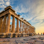 Low angle perspective of columns of the Parthenon at sunset, Acropolis, Athens